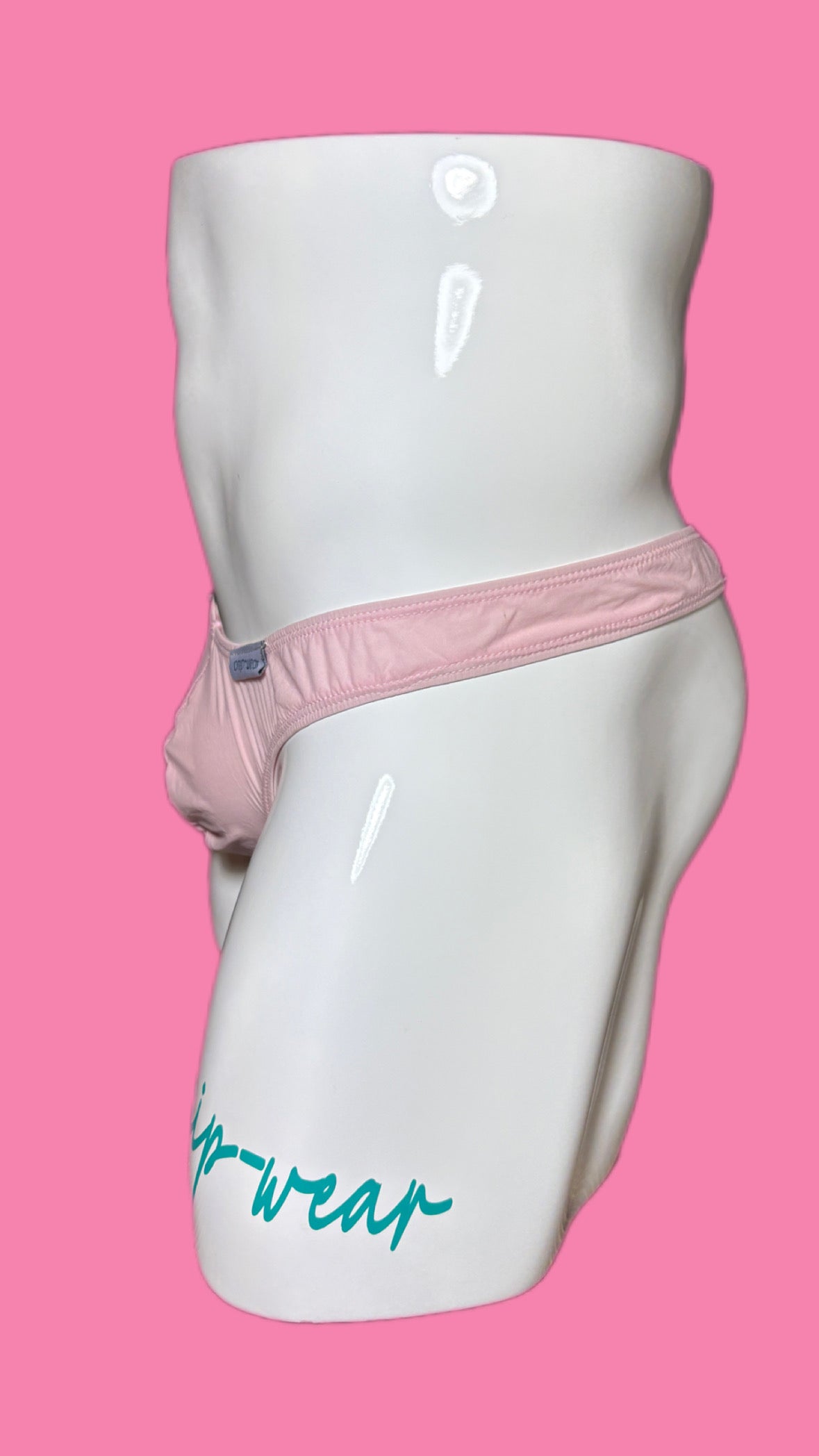 White mannequin wearing pink underwear with Onip-Wear branding on a pink background