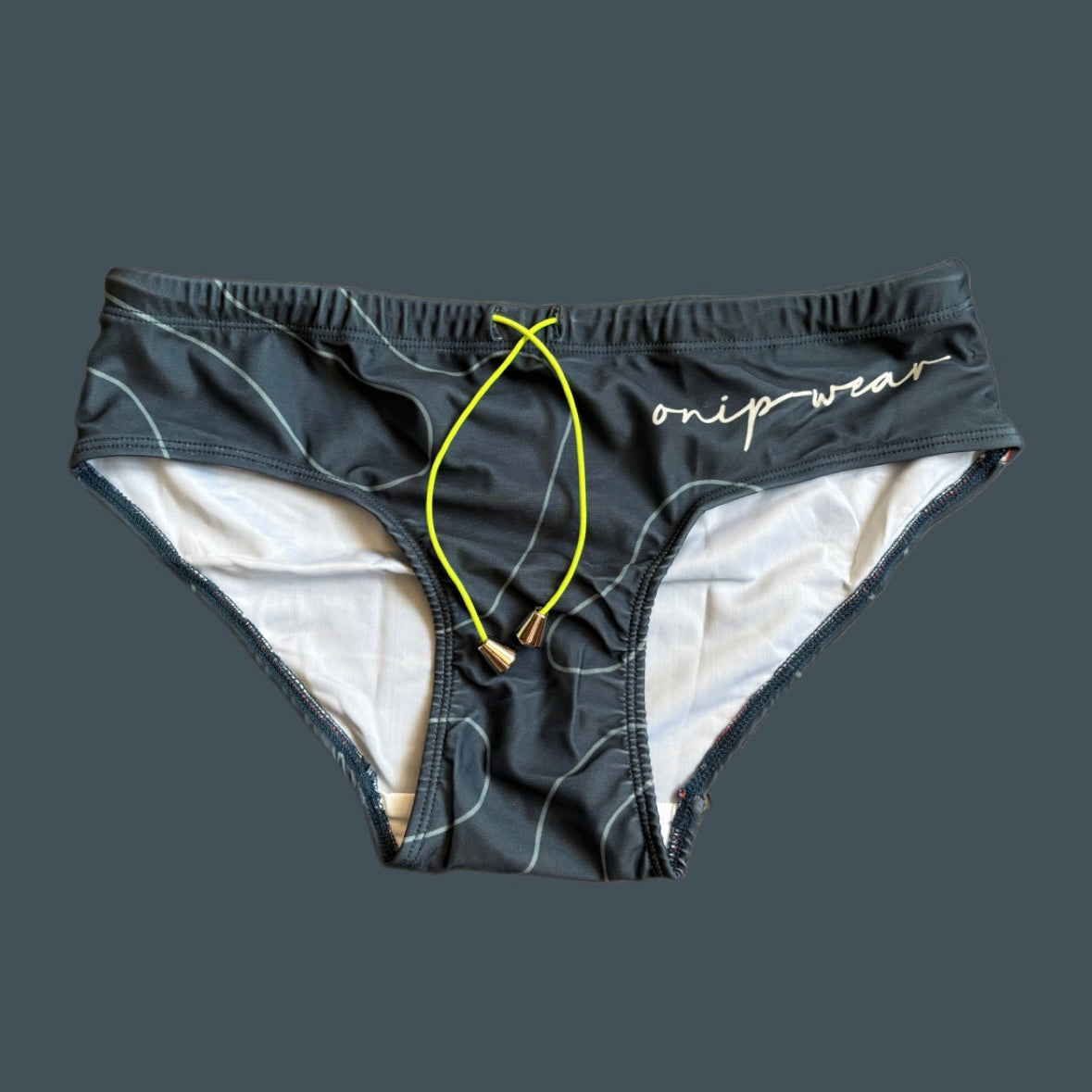 Grey swim briefs with yellow drawstring on a gray background