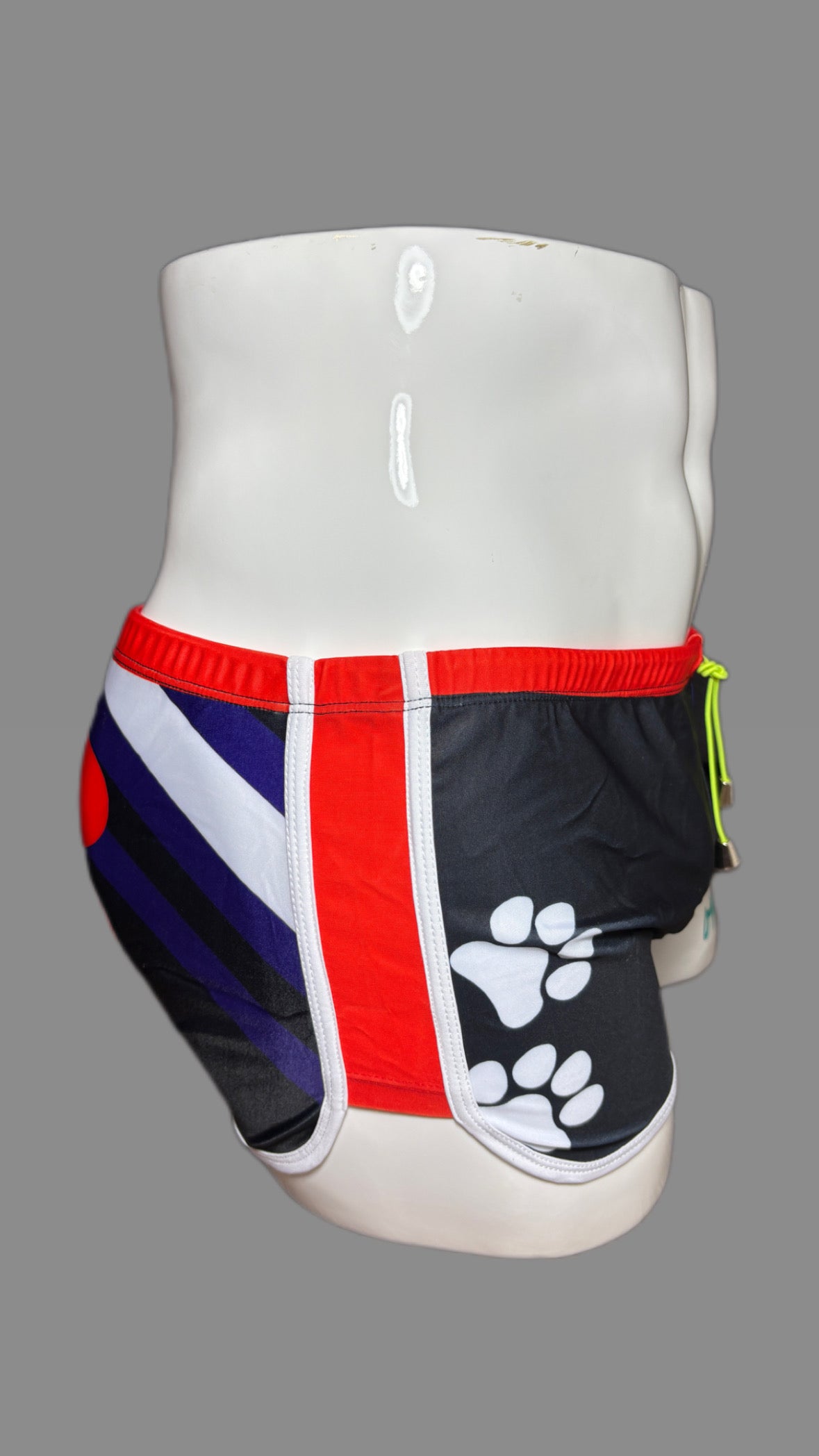 Pup Pride swimwear black blue and red with paw prints by Onip-wear.