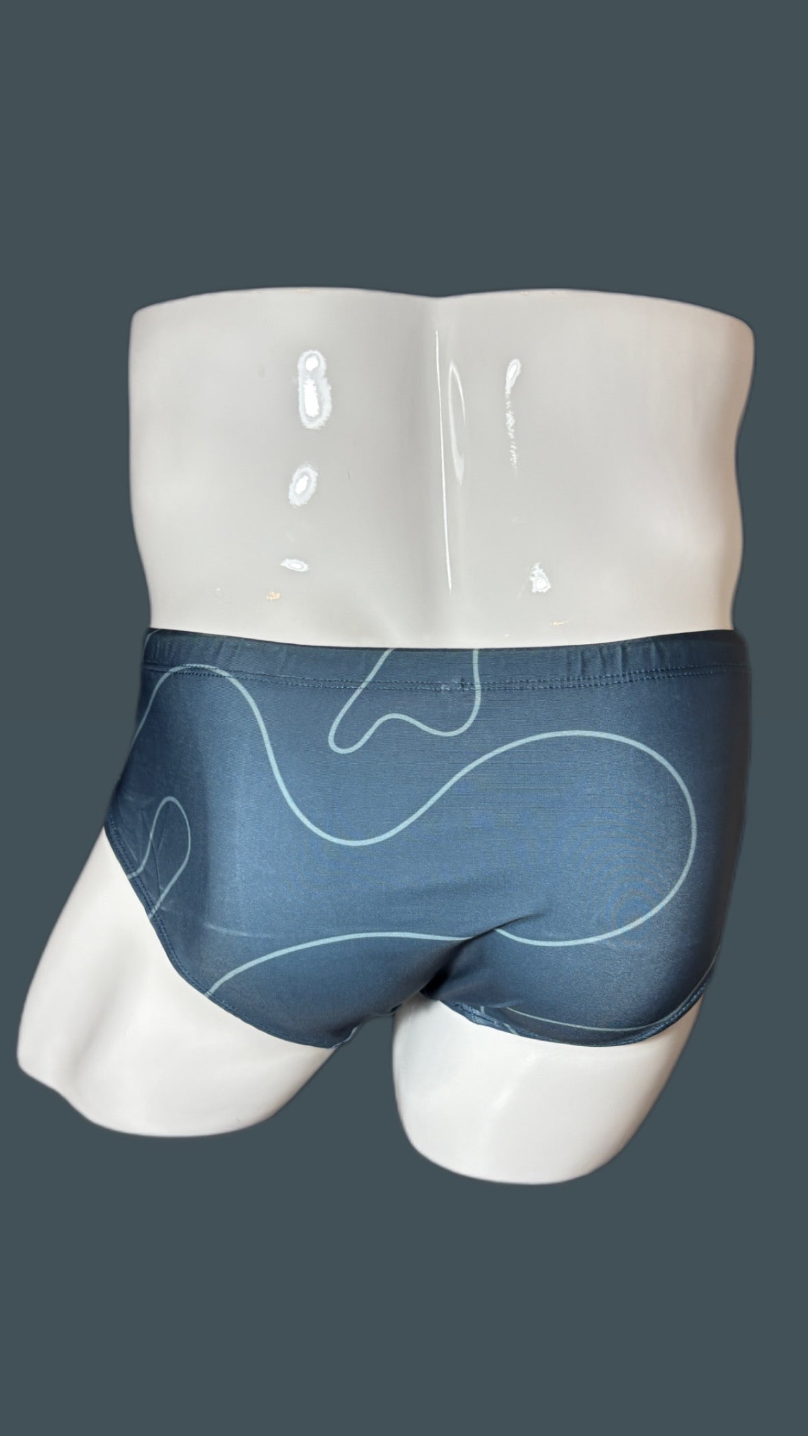 grey swimwear with geometric lines on grey background