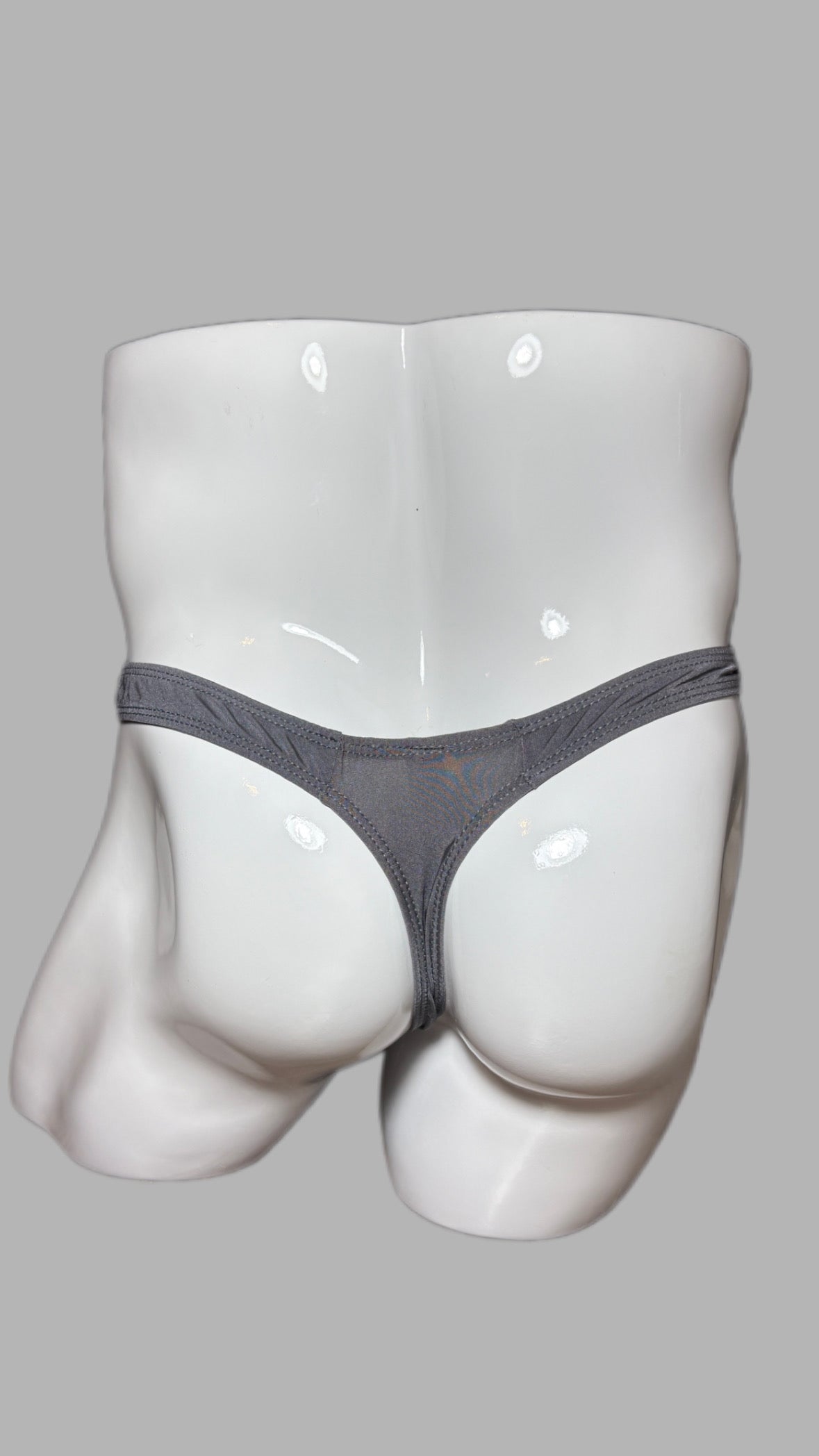Gray thong on a mannequin against a gray background
