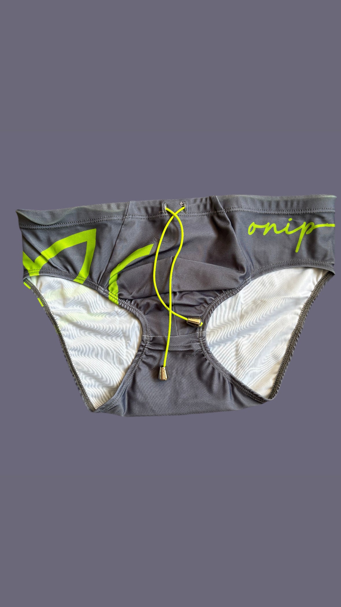 Gray swim briefs with green accents on a mannequin against a gray background