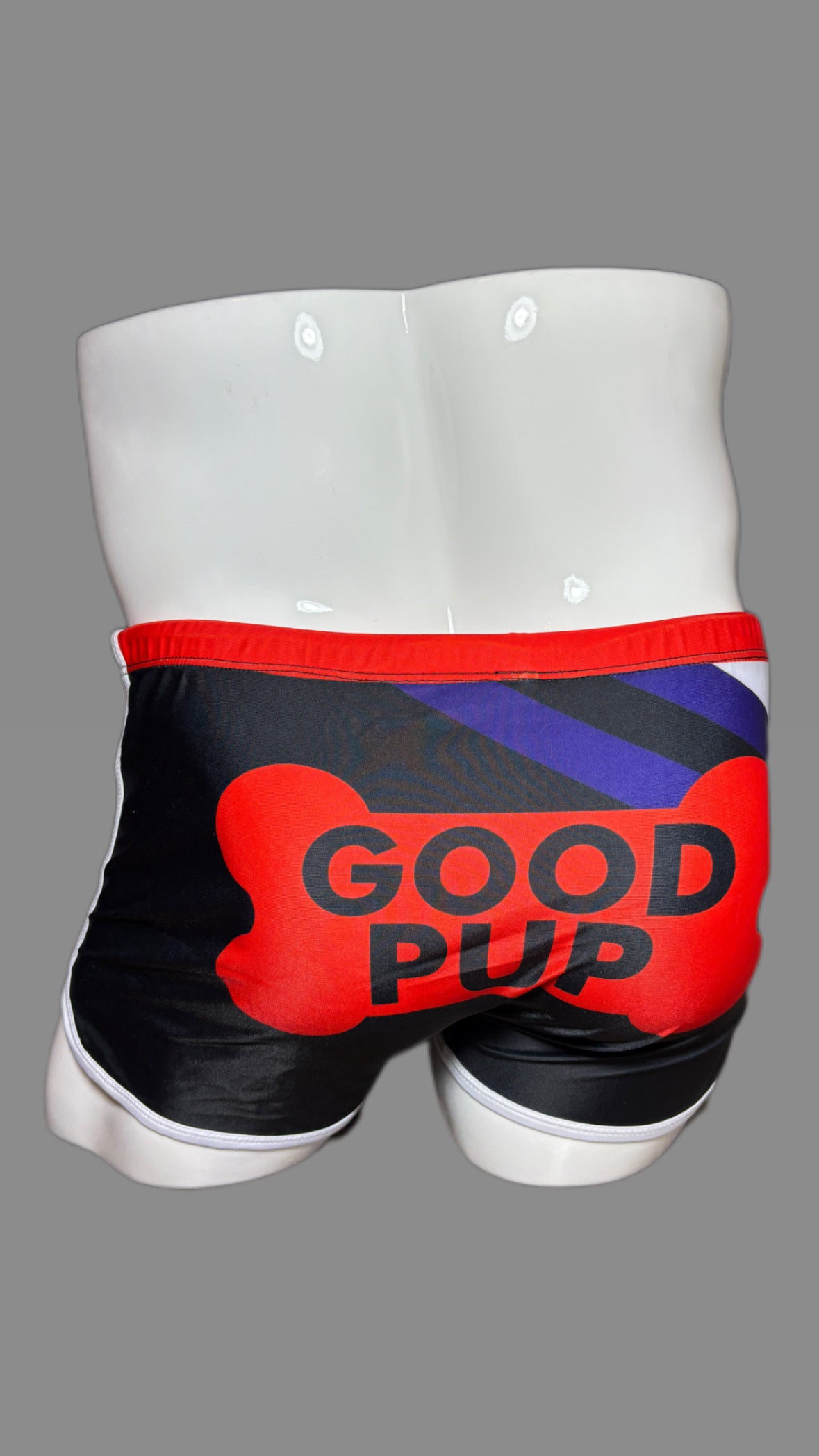 Pup Pride swimwear black blue and red with paw prints by Onip-wear. 