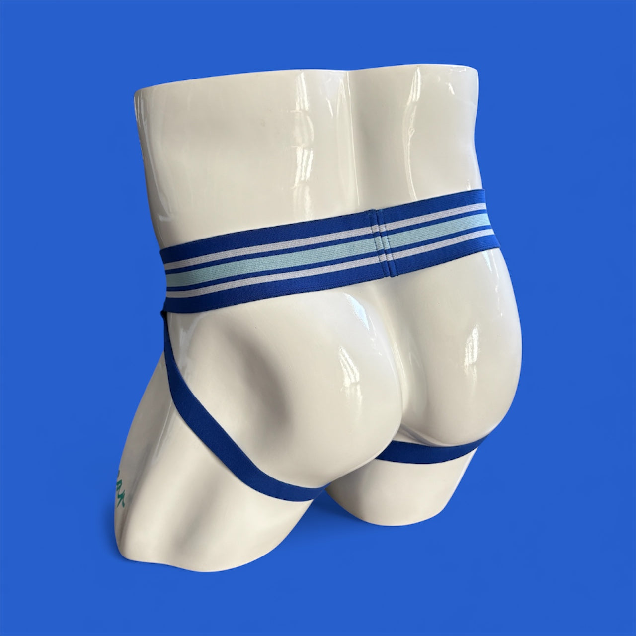 Blue jockstrap with wide waistband on mannequin with blue background 