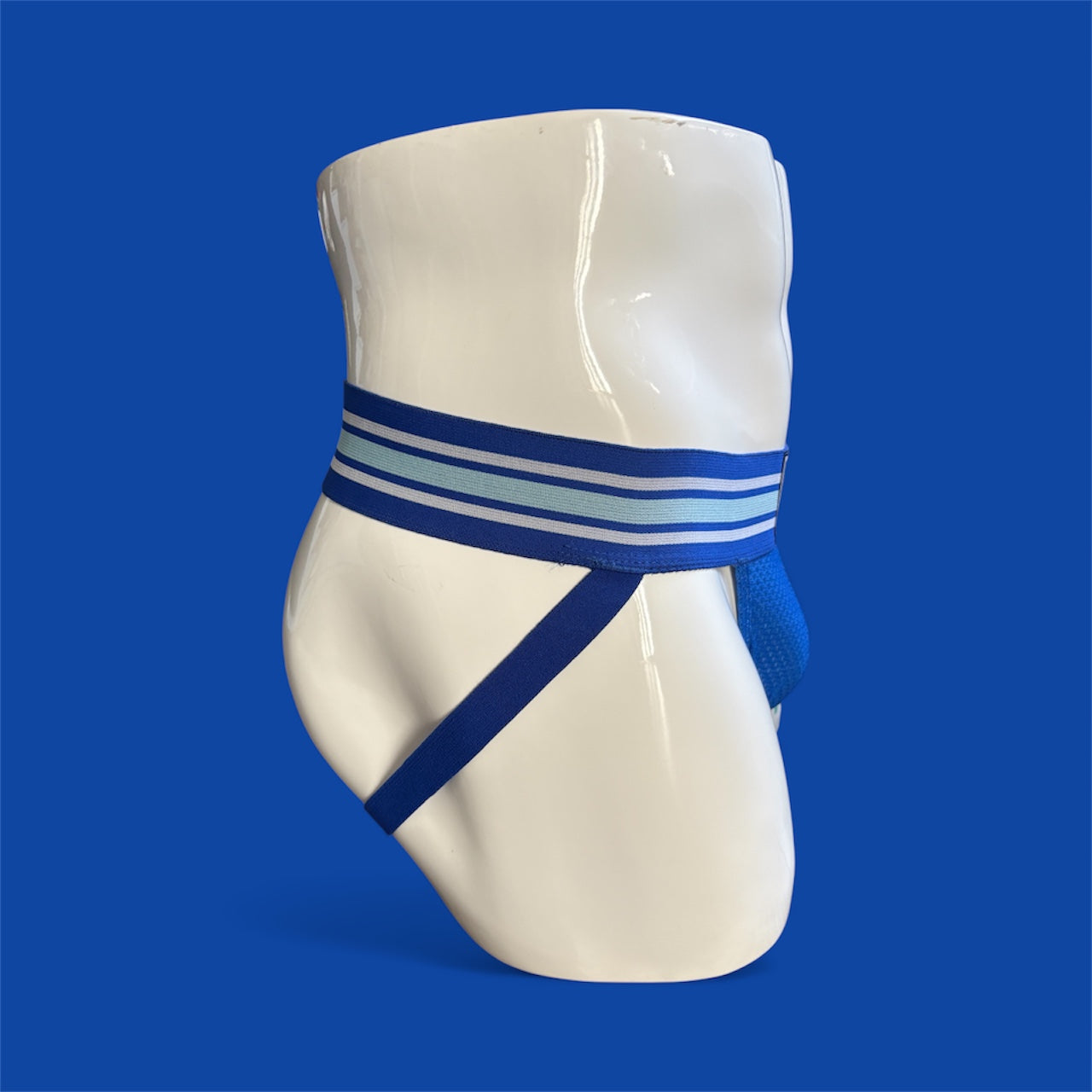 Blue jockstrap with wide waistband on mannequin with blue background 