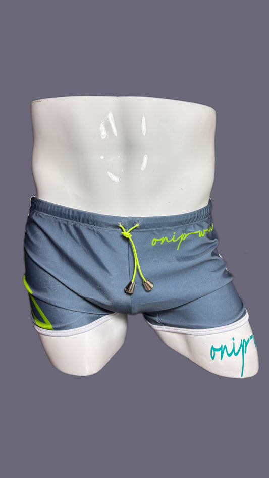 Gray shorts with green drawstring and 'onip' branding on a mannequin against a gray background