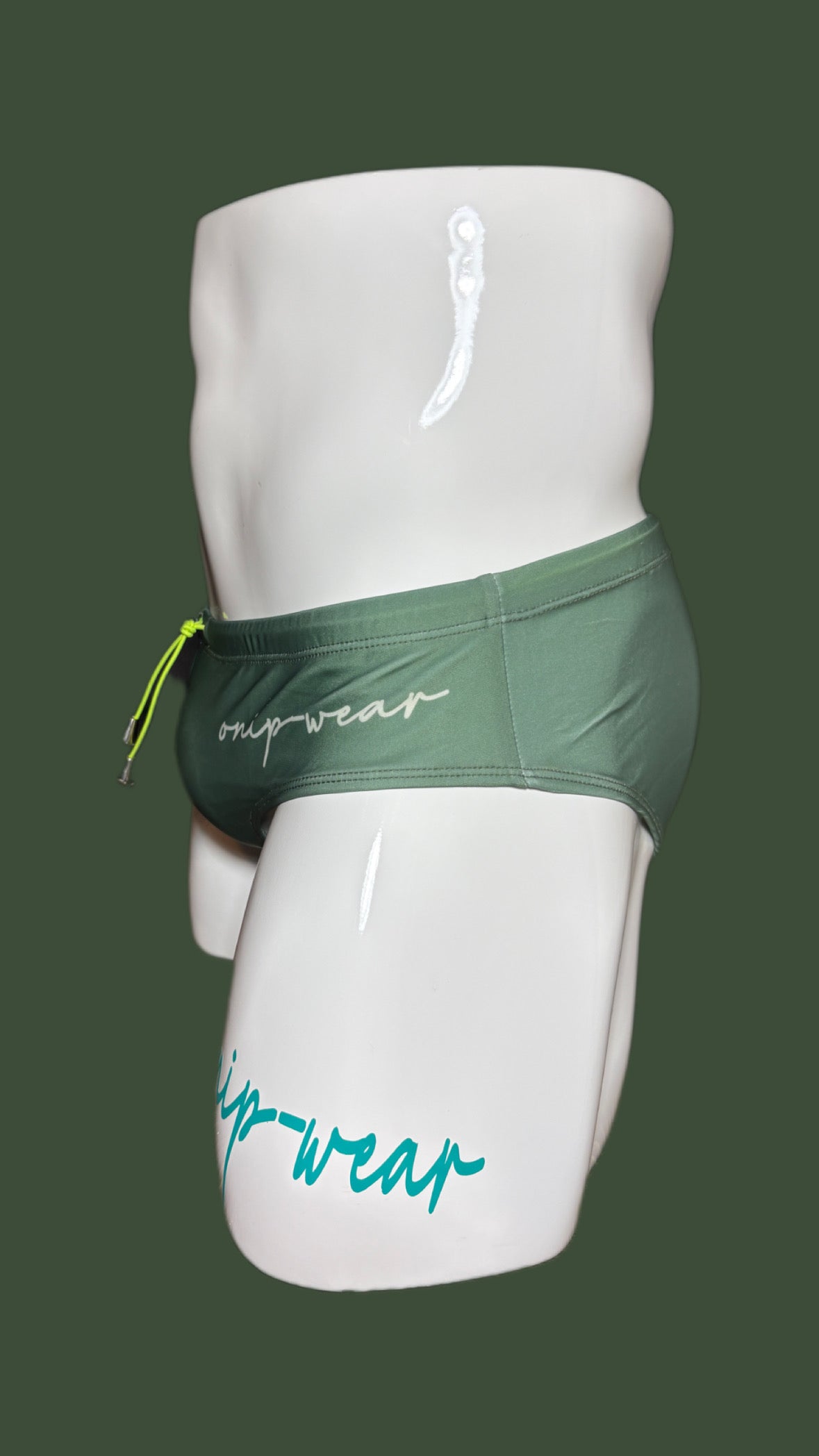 Green men's underwear on a mannequin with 'onip-wear' branding against a green background